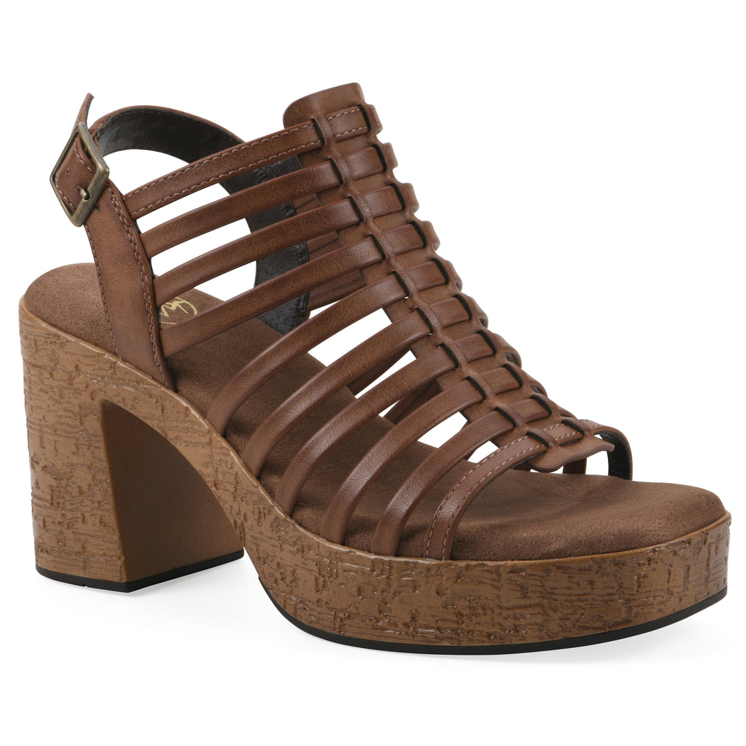 Angle view of a brown gladiator platform sandal with adjustable ankle buckle and cork style heel