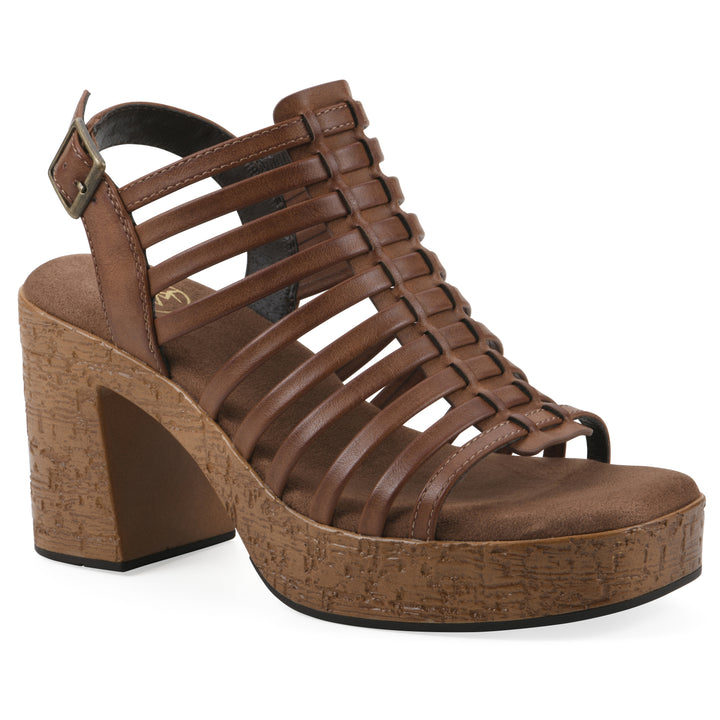 Angle view of a brown gladiator platform sandal with adjustable ankle buckle and cork style heel