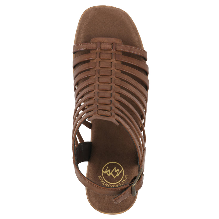 Top view of a brown gladiator platform sandal with adjustable ankle buckle and cork style heel