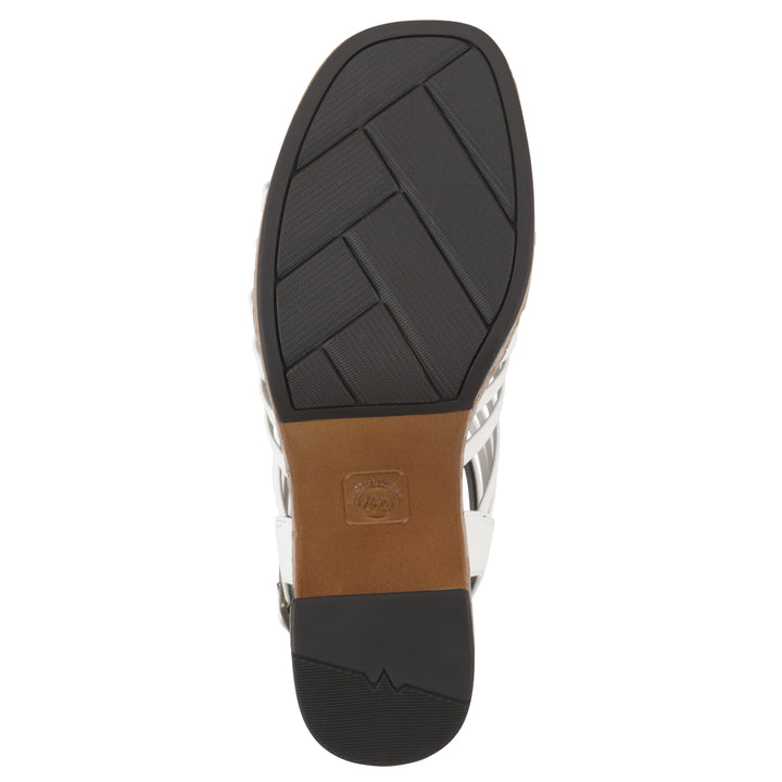 Sole view of a white gladiator platform sandal with adjustable ankle buckle and cork style heel