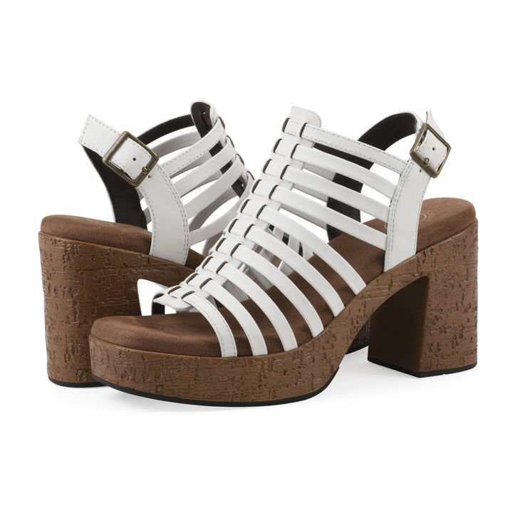 Angle view of a pair of white gladiator platform sandals with adjustable ankle buckle and cork style heel