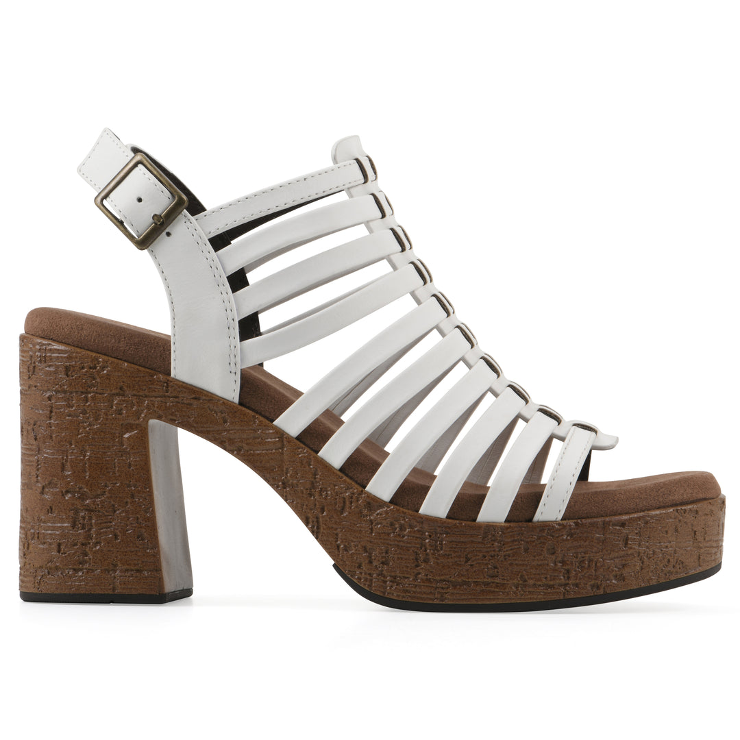 Side view of a white gladiator platform sandal with adjustable ankle buckle and cork style heel