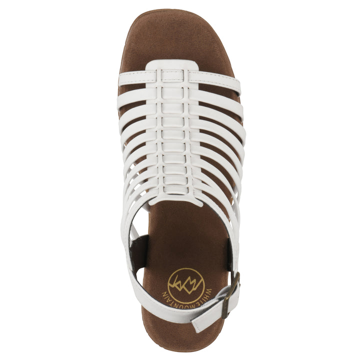 Top view of a white gladiator platform sandal with adjustable ankle buckle and cork style heel