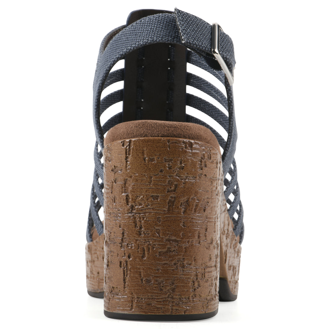 Rear view of a denim gladiator platform sandal with adjustable ankle buckle and cork style heel