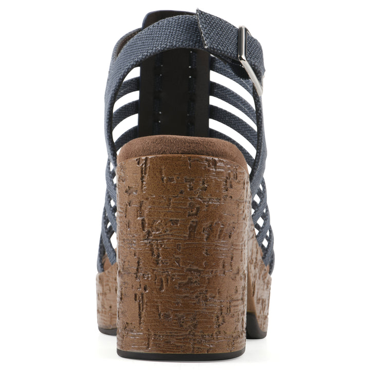 Rear view of a denim gladiator platform sandal with adjustable ankle buckle and cork style heel