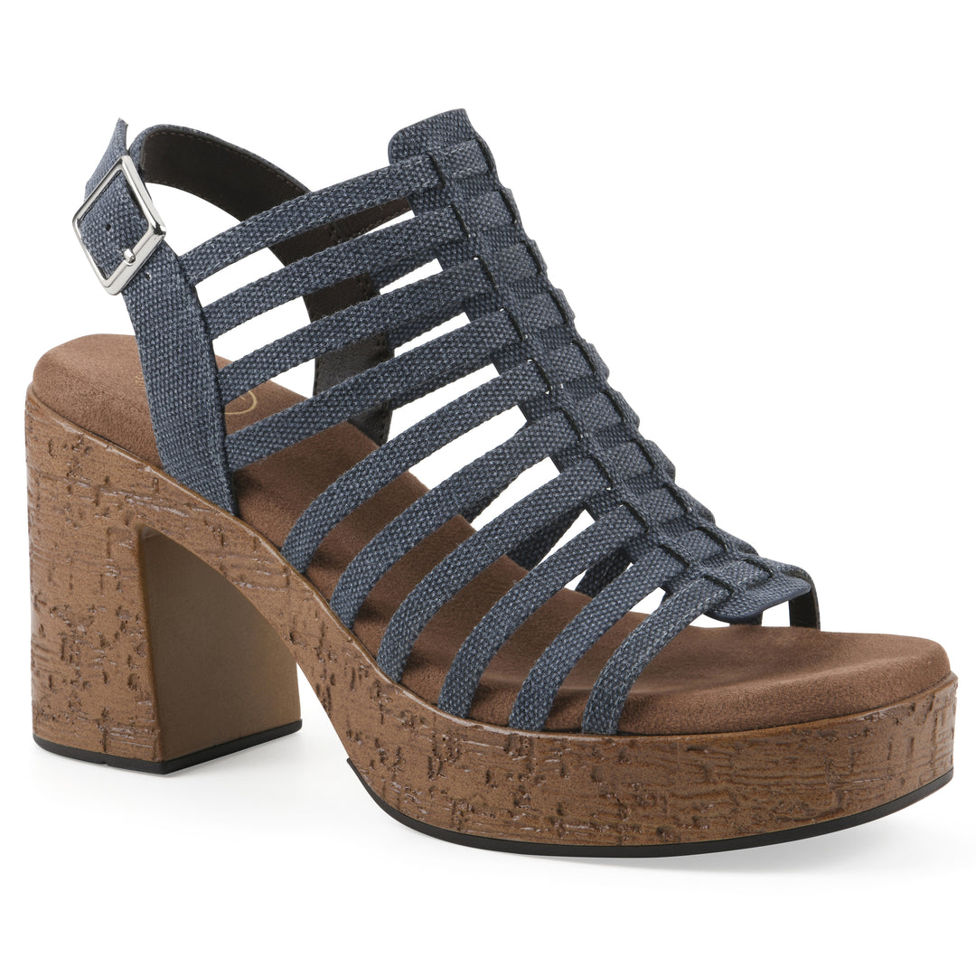 Angle view of a denim gladiator platform sandal with adjustable ankle buckle and cork style heel