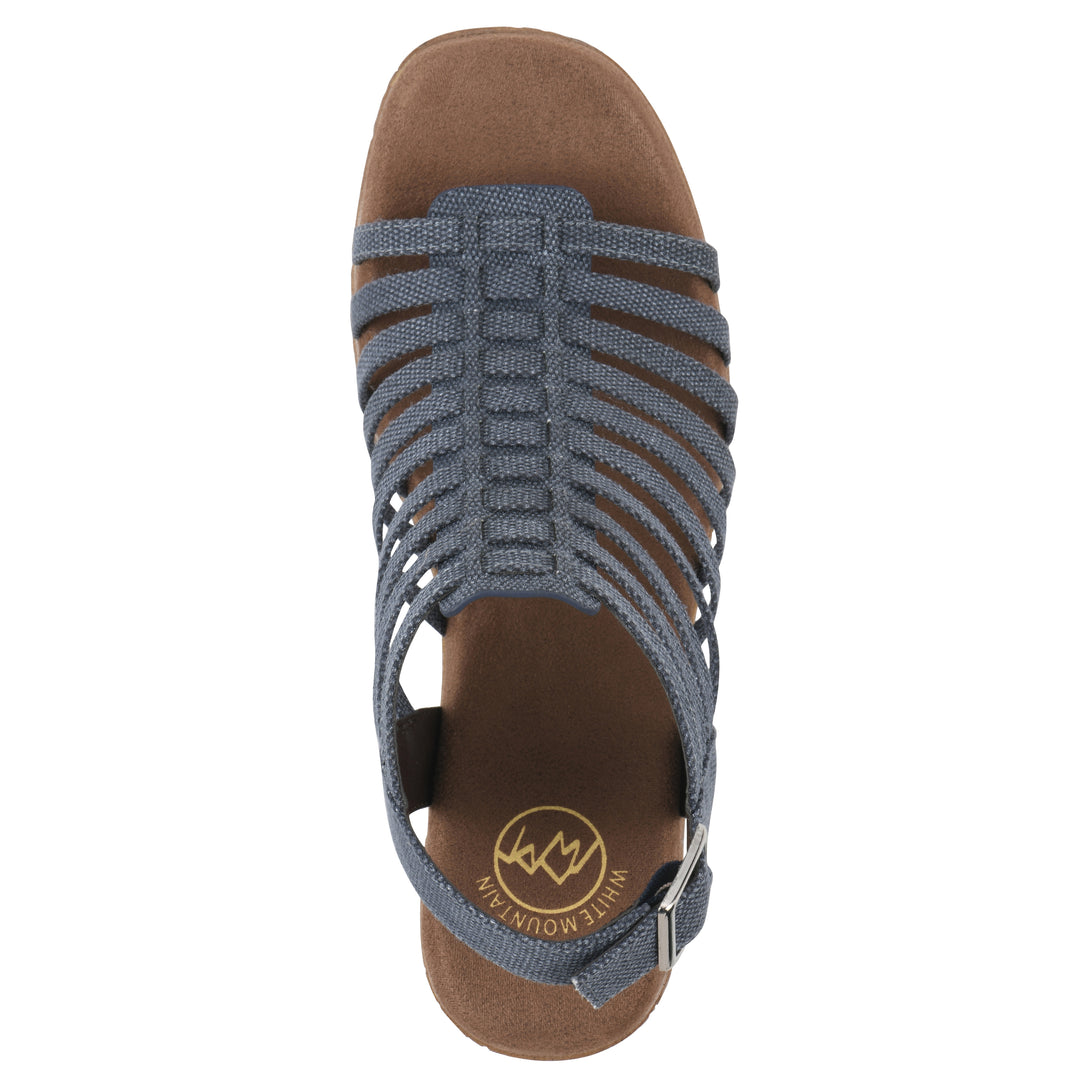 Top view of a denim gladiator platform sandal with adjustable ankle buckle and cork style heel