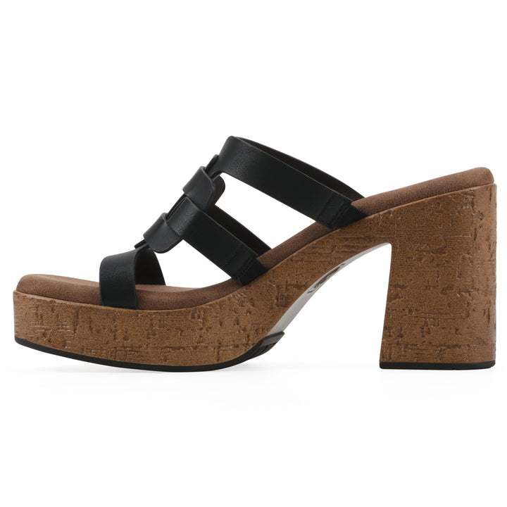 Side view of a black faux leather platform sandal, with multi-interlaced straps and a brown cork style sole