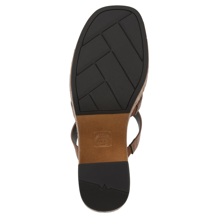 Sole view of a brown faux leather platform sandal, with multi-interlaced straps and a brown cork style sole with black bottom