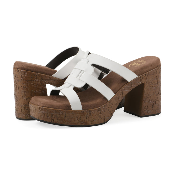 Angle view of a pair of white faux leather platform sandals, with multi-interlaced straps and a brown cork style sole