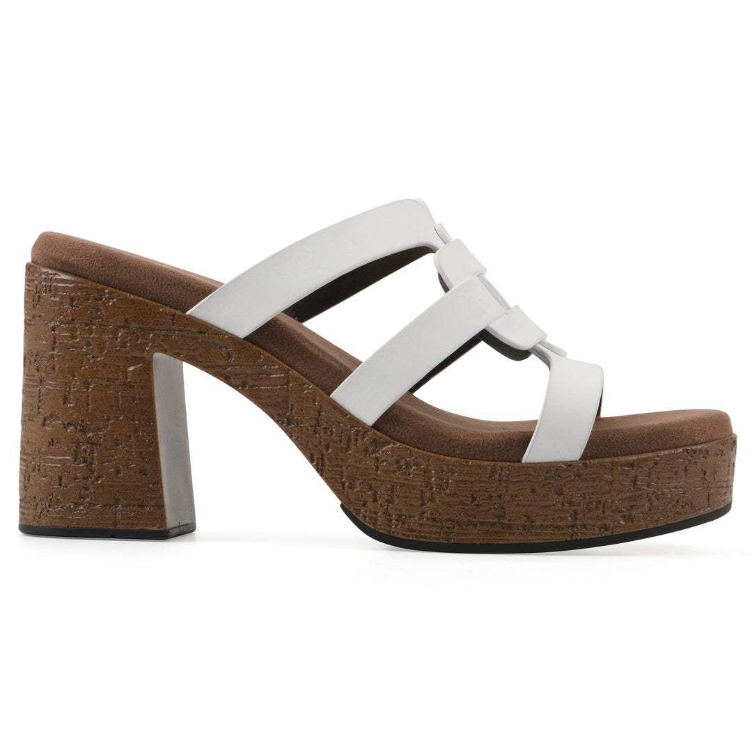 Side view of a white faux leather platform sandal, with multi-interlaced straps and a brown cork style sole