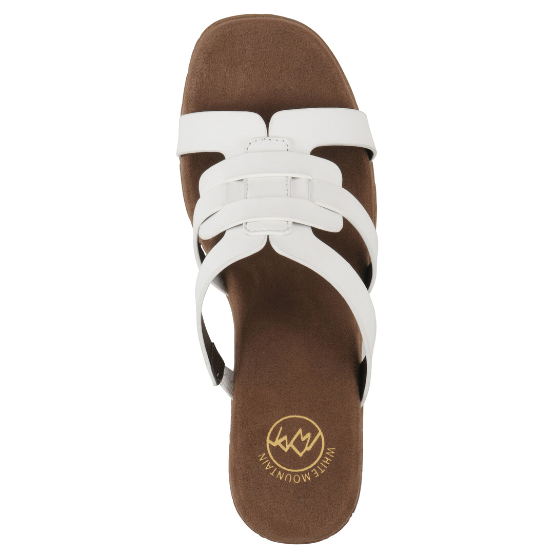 Top view of a white faux leather platform sandal, with multi-interlaced straps and a brown cork style sole